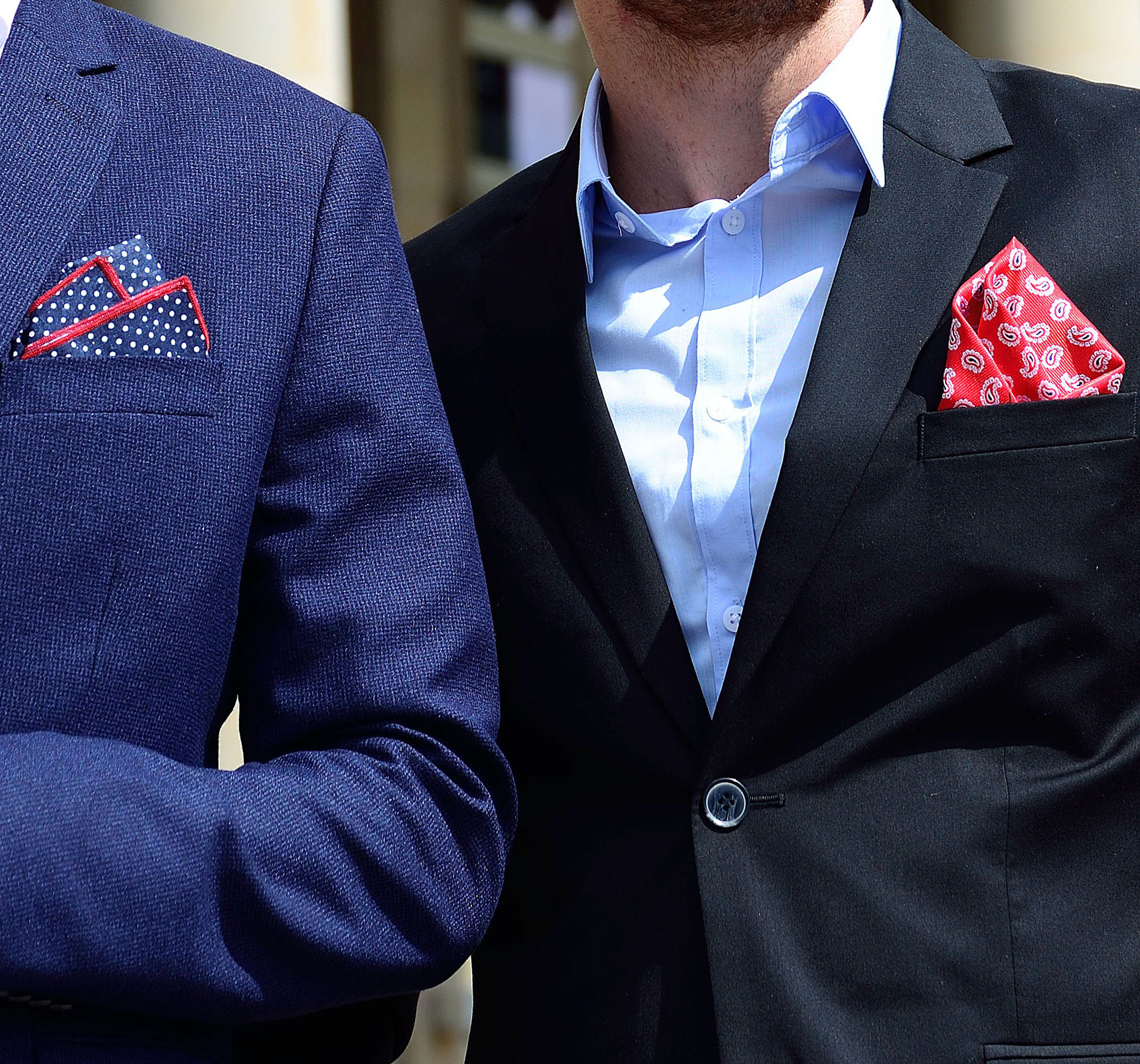 Monumental building with two men in front and gorgeous pocket squares by di Venisco.