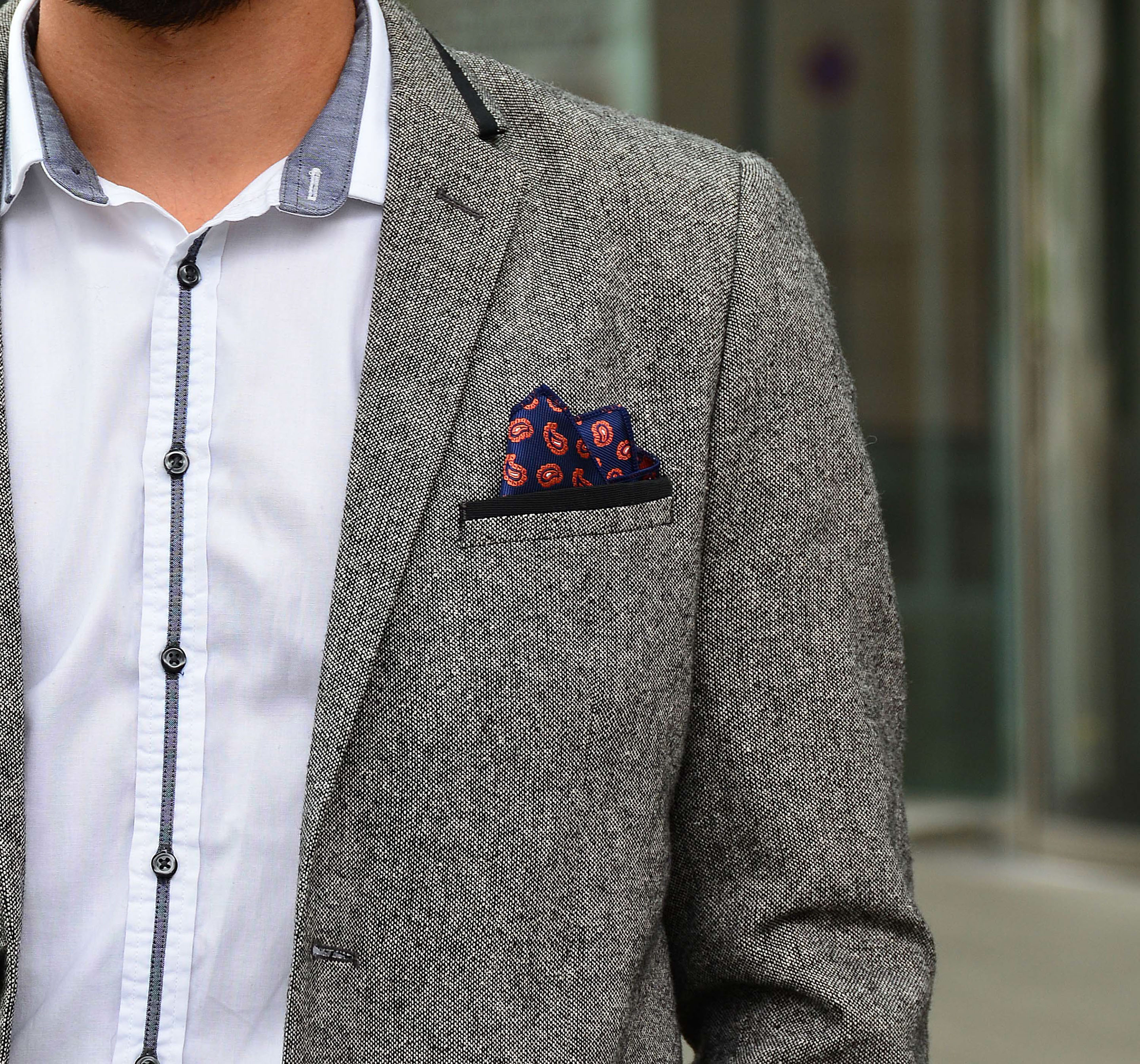 Monumental building with two men in front and gorgeous pocket squares by di Venisco.