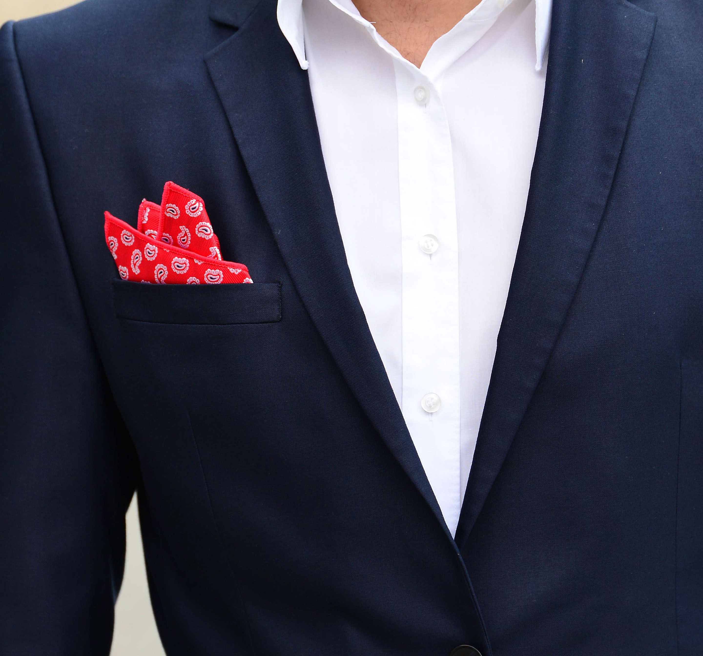 Monumental building with two men in front and gorgeous pocket squares by di Venisco.